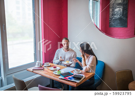 Couple discussing desserts while working on new seasonal menu Couple discussing desserts while working on new seasonal menu 59923795