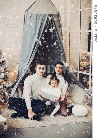 Beautiful young family under baldachin. Christmas Beautiful young family under baldachin. Christmas 59923845