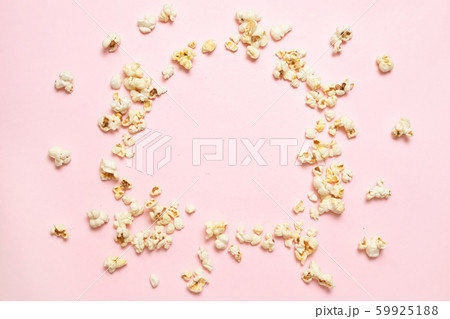 Top view of popcorn frame on pink background with 59925188