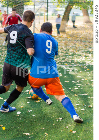 Soccer Players Performs An Action Play On A の写真素材