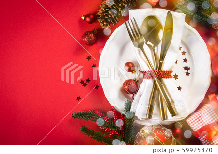 Christmas tableware and decorations on red background Christmas tableware and decorations on red background 59925870