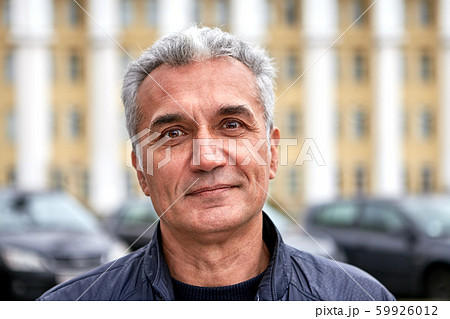 Mature handsome man is posing outdoors. Mature handsome man is posing outdoors. 59926012