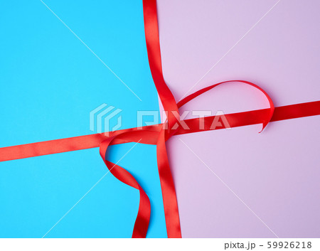 red satin ribbon on a colored background 59926218