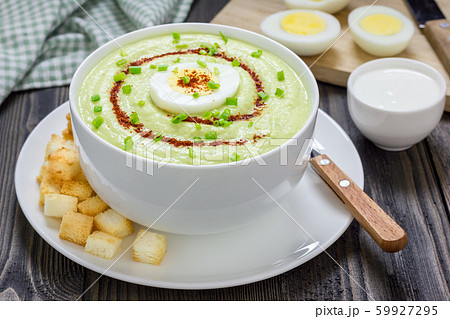 Cream soup with avocado, garnished with egg Cream soup with avocado, garnished with egg 59927295