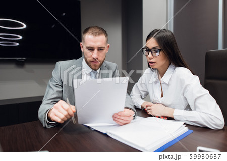 Business, office, law and legal concept - picture of man and woman hand signing contract paper Business, office, law and legal concept - picture of man and woman hand signing contract paper 59930637