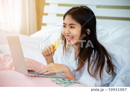 Asian teenage woman use laptop and credit-card on Asian teenage woman use laptop and credit-card on 59931067