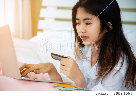 Asian teenage woman use laptop and credit-card on Asian teenage woman use laptop and credit-card on 59931069