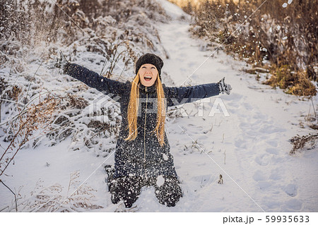 Woman has fun in winter, throws snow Woman has fun in winter, throws snow 59935633