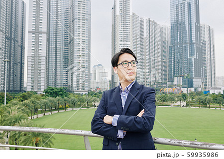Businessman on bridge over park Businessman on bridge over park 59935986