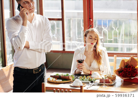Bored woman at restaurant table 59936371