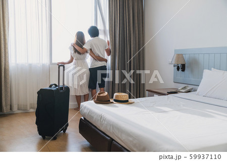 Young couple traveler with luggage looking at view Young couple traveler with luggage looking at view 59937110