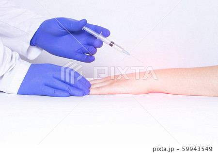 Doctor injects blockade into wrist joint with chondroprotector and analgesic drug, close-up, medical, ozone therapy, polyarthritis 59943549