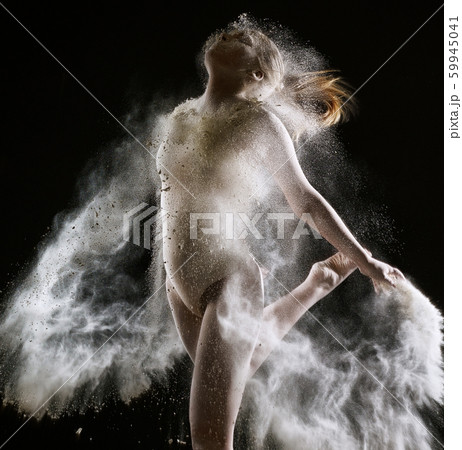 Sexy slim girl in white dust cloud studio portrait 59945041