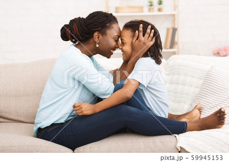 Happy black mom hugging her little girl 59945153