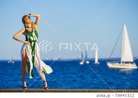 Fashion woman against yachts on sea Fashion woman against yachts on sea 59945312