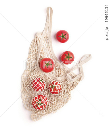 Clean and eco tomatoes in reusable net bag on white Clean and eco tomatoes in reusable net bag on white 59946134