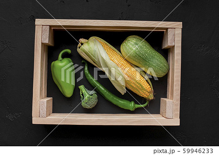 Picture of fresh vegetables inside wooden frame on black Picture of fresh vegetables inside wooden frame on black 59946233