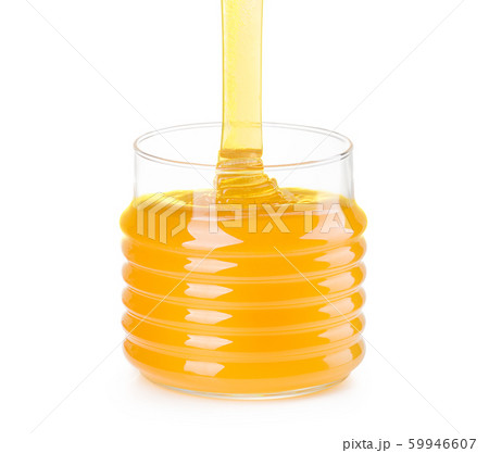 Glass jar of honey and falling jet of honey isolated on white background Glass jar of honey and falling jet of honey isolated on white background 59946607