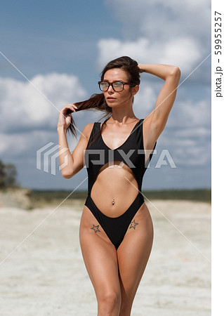 Beautiful woman in swimsuit on beach Beautiful woman in swimsuit on beach 59955257