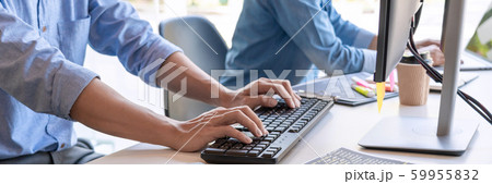 Pensive programmer working on on desktop pc 59955832