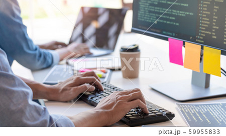 Pensive programmer working on on desktop pc 59955833