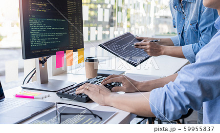 Pensive programmer working on on desktop pc 59955837