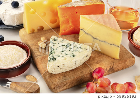 Cheese platter. Blue cheese, red Leicester, Brie, Emmental and others with wine and grapes on a white background 59956192