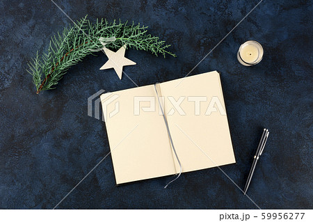 New Year's resolutions or bucket list concept, a flat lay overhead mock-up with copy space, on a dark blue background with a pen, a candle, and a star 59956277