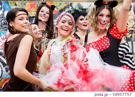 Group of women in sexy costumes at carnival party 59957757