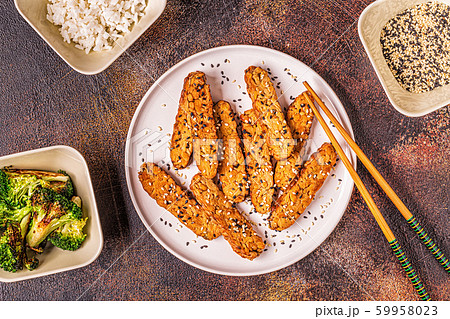 Fried tempeh  with sesame seeds. 59958023
