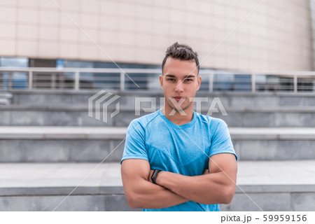Male athlete posing confidently looking, coach summer day city, building background. Active youth lifestyle, fitness workout nature. Free space for text strength and motivation. 59959156