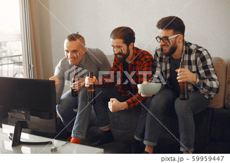 Group of fans are watching a soccer moment on the TV Group of fans are watching a soccer moment on the TV 59959447