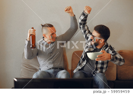 Group of fans are watching a soccer moment on the TV Group of fans are watching a soccer moment on the TV 59959459