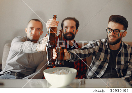 Group of fans are watching a soccer moment on the TV 59959495