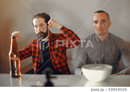 Group of fans are watching a soccer moment on the TV 59959509