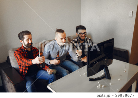 Group of fans are watching a soccer moment on the TV 59959677