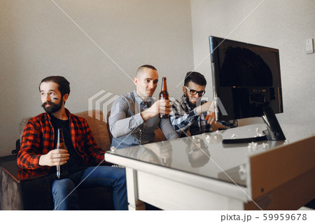 Group of fans are watching a soccer moment on the TV 59959678