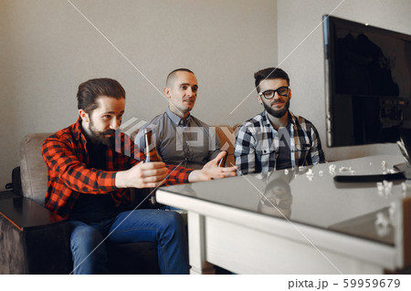 Group of fans are watching a soccer moment on the TV 59959679