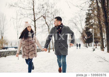 Cute and loving couple in a winter city Cute and loving couple in a winter city 59960976
