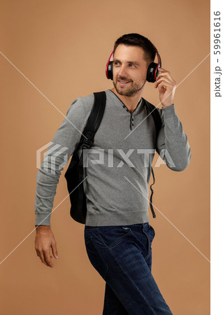handsome young man with headphones and backpack 59961616