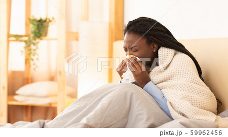 Sick Black Girl Blowing Nose Sitting In Bed, Panorama 59962456