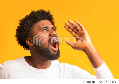 Portrait of shocked black guy screaming over orange background Portrait of shocked black guy screaming over orange background 59963183