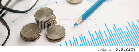Pile of silver coins lying at financial chart document Pile of silver coins lying at financial chart document 59963208