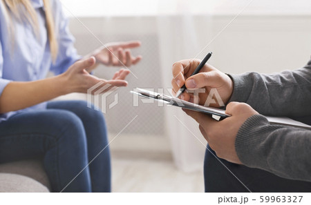 Millennial woman discussing problems with personal therapist Millennial woman discussing problems with personal therapist 59963327