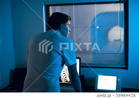 in the Medical Laboratory the Radiologist in the Control room Monitors the Skeleton and ribs of the patient MRI or CT in the Medical Laboratory the Radiologist in the Control room Monitors the Skeleton and ribs of the patient MRI or CT 59964428