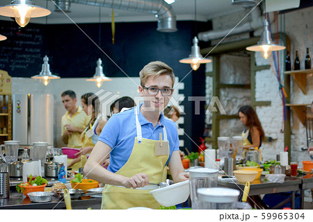 Cooking class. young happy friends in the kitchen Cooking class. young happy friends in the kitchen 59965304