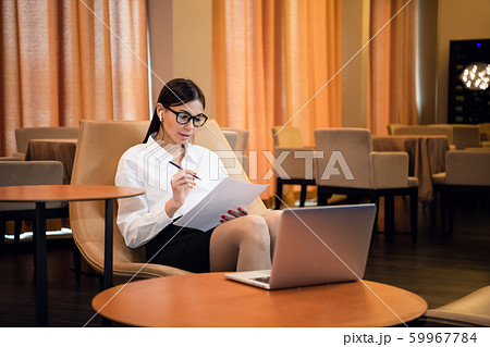 Businesswoman Using Laptop In Airport Departure Lounge Businesswoman Using Laptop In Airport Departure Lounge 59967784