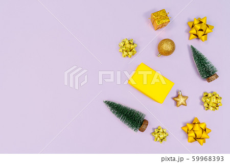 Christmas decoration. Gifts, yellow and golden decorations on purple background. Christmas, winter 59968393