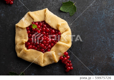 Homemade red currants tart with leaves. Vegetarian healthy galette decorated with fresh red currant. Delicious dessert. Homemade red currants tart with leaves. Vegetarian healthy galette decorated with fresh red currant. Delicious dessert. 59975726