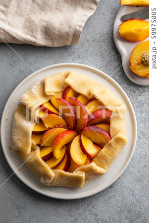 Appetite summer peach galeta on white table with copy space. summer open tart photo for cook book or food blog. Appetite summer peach galeta on white table with copy space. summer open tart photo for cook book or food blog. 59975805